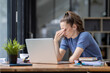 © David - Portrait of tired young business Canada woman work with documents tax laptop computer in office. Sad, unhappy, Worried, Depression, or employee life stress concept