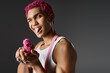 © LIGHTFIELD STUDIOS - playful pink haired male model sticking out his tongue and leveling his pink toy gun at camera