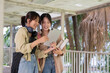 © Natee Meepian - Two college student female friends smile ready for class at the university campus