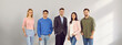 © Studio Romantic - Group of young people men and women looking at camera and smiling on gray wall background. Company employees team or staff or a group of students standing in a row confidently and cheerfully. Banner.