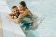 © BGStock72 - Young couple relaxing in the indoor swimming pool