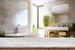 Empty wooden table and blurred view of stylish bathroom interior.
