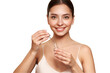 Beautiful elegant woman holding a cosmetic jar of oil serum or hyaluronic acid in her hand. Perfect facial skin