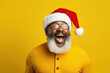 © Art AI Gallery - African american man wearing santa claus hat celebrating christmas over yellow background very happy and excited screaming with smile