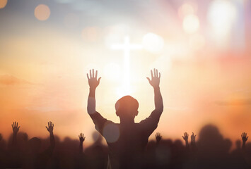 Wall Mural - silhouette christian reaching hands over blurred cross sunset background