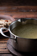 Boiled fatty broth in a saucepan