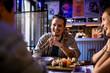 © Marko Geber - Happy young man eating sushi with his friends in a restaurant