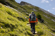 © Guzel - A man with a backpack climbs a steep path to a rock ridge in the Austrian Alps