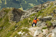 © Guzel - Man stopped on climb on rocky trail and resting on rocky ridge background, Austria
