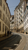 Fototapeta Miasto - Lisbon, Portugal - May 25, 2023: Narrow street of Lisbon historical center