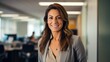 © Matthew - Portrait of attractive confident businesswoman looking at camera in the office