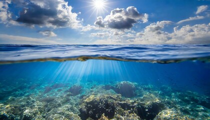 blue sea or ocean water surface and underwater with sunny and cloudy sky