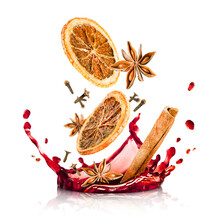 Splashes Of Mulled Wine And Falling Cinnamon, Dried Orange, Anise And Cloves, Isolated On A White Background