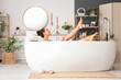 © Pixel-Shot - Young woman taking bath at home