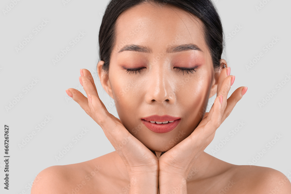 Beautiful Asian woman on light background, closeup