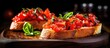 Delicious Italian appetizers bruschetta with tomato on toasted baguette topped with basil on a wooden board