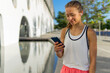 © ADDICTIVE STOCK - A young running girl is looking at her cell phone