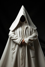 Mysterious Man In White Hooded Robe Against Dark Background