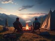 Two people camping outdoors sitting next to a tent, a campfire burning beside them, rolling mountains and forests in the distance