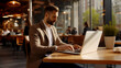 © PETR BABKIN - YOUNG MANAGER WORKING ON A LAPTOP IN A CAFE. legal AI