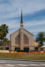 Non-denominational Church With Tall Metal Steeple. Fall Pumpkin Patch In Front Of Church.
