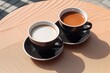 Cups of freshly ground brewed black coffee in stylish plain mugs. Americano, espresso, suitable for coffee shops and as a mockup for logos.