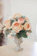Many orange roses in a vase. Selective focus.
