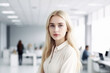 © TATIANA KIM - Portrait of a young blonde woman with long hair in shirt against the background of the office.