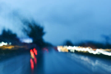 Wall Mural - light of car on road in the night, blurred traffic jam background with rain