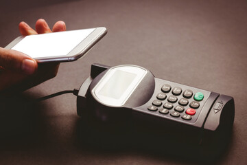 Canvas Print - Digital png photo of male hand holding smartphone over device, copy space on transparent background