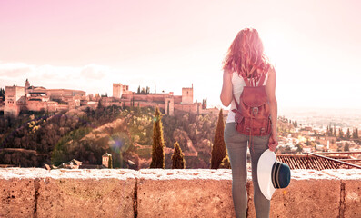 Wall Mural - Tourism at Granada at sunset- Andalusia in Spain- Woman looking at Alhambra