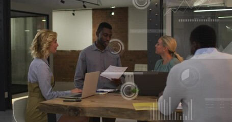 Canvas Print - Animation of graphs, loading bars and circles over diverse coworkers sharing ideas in office