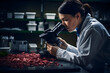 a young woman scientist is analyzing through a microscope in a clinical laboratory of the medical industry.