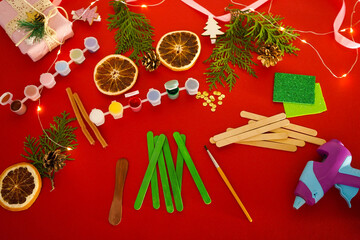 Wall Mural - Step by step instruction how to make christmas tree from ice cream sticks. Step 2 painting sticks green and brown. Children's New year handmade craft