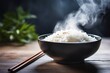 © The Little Hut - Generative AI : Japanese rice, Cook rice. Close up natural steaming cooked Japanese white rice in black bowl with chopstick on black background