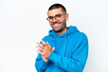 Young caucasian man isolated on white background With glasses and applauding