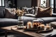 Glass jar with dried flowers, vase, and candle on wooden tray on coffee table over sofa with cushions. Gray and brown interior decoration. Decor for the living room