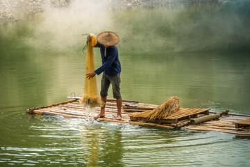 Wall Mural - view of fishermen fishing on river in Thung mountain in Tra Linh, Cao Bang province, Vietnam with lake, cloudy, nature