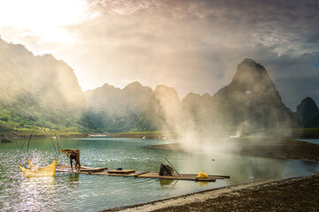 Wall Mural - view of fishermen fishing on river in Thung mountain in Tra Linh, Cao Bang province, Vietnam with lake, cloudy, nature