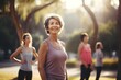 © AKKA - Active graceful Senior Women and Friends Practicing Yoga in Lively Park Stretching muscle health, workout, and training with the retirement community