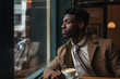 © M.Gierczyk - Young African Man Enjoying Coffee by the Window