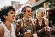 group of diverse tattooed trans woman drinking coffee smiling in the city 