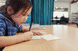 © Austockphoto - Young student girl writing in libary