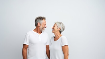 senior couple laughing together on white background copy space 