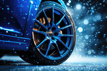 Blue futuristic car with winter tires on snow covered road. Close-up on wheels