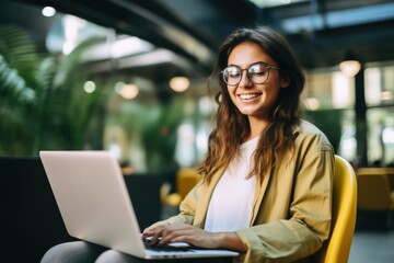 Wall Mural - Woman Sitting in Chair Engaged in Laptop Work