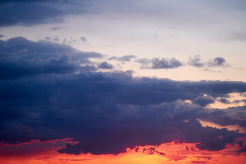 Wall Mural - The evening sky was a canvas of oranges and reds, reflecting the fading light.