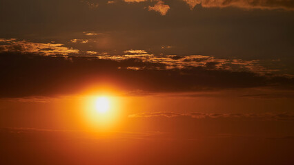 Wall Mural - The setting sun painted the sky with a golden hue, casting long shadows across the land.