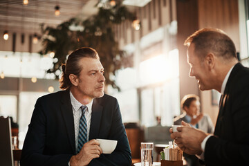 Wall Mural - Business partners talking in a coffee shop