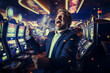 Excited man celebrating winning money in the casino. Male player by the slot machines. Gambling addiction.